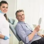 Dental hygienist and man in dental chair