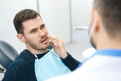 Man in dental chair with toothache
