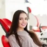 young woman sitting in dental chair