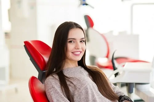 young woman sitting in dental chair